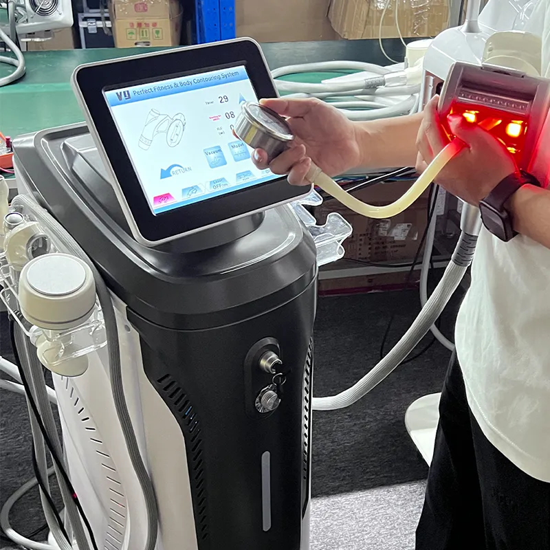 Workshop real shot article front image of vacuum roller slimming machine, technician holding infrared vacuum roller handpiece, touch screen vacuum roller body contour equipment for salon cellulite reduction and lymphatic drainage treatment