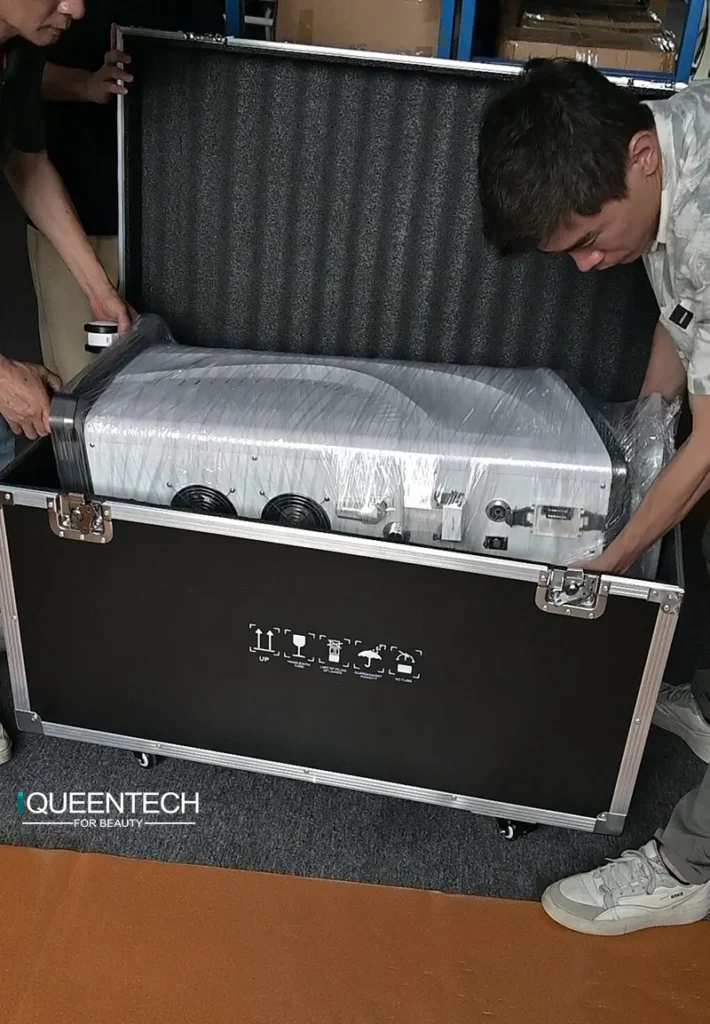 Workers placing Lymphatic Roller Machine into shockproof aluminum flight case with custom molded EPE foam for safe export shipping