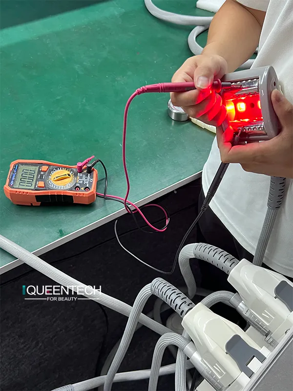 Technician uses multimeter to conduct power and RF output testing on medium roller handpiece of Lymphatic Roller Machine during pre-shipment quality inspection