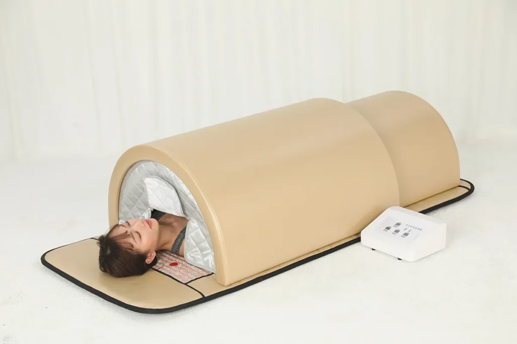 Woman receiving body detox therapy inside infrared sauna dome for weight loss and skin rejuvenation